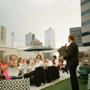 Intimate rooftop wedding in downtown Denver featuring city skyline views and minimal décor