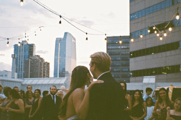 Bride and groom overlooking the Denver skyline at Rooftop1630 wedding venu